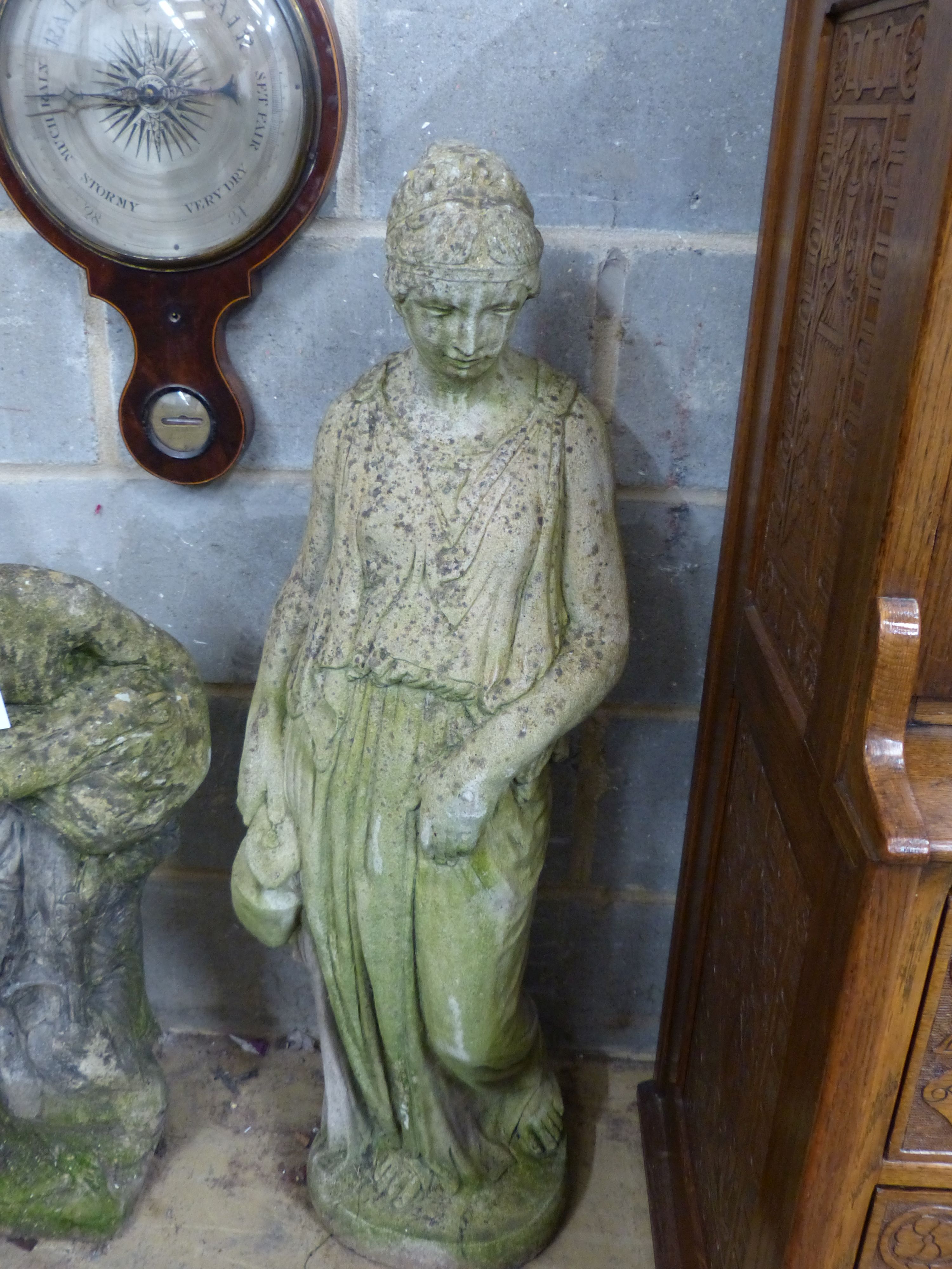 Two reconstituted stone garden statues and a bird bath, largest height 99cm